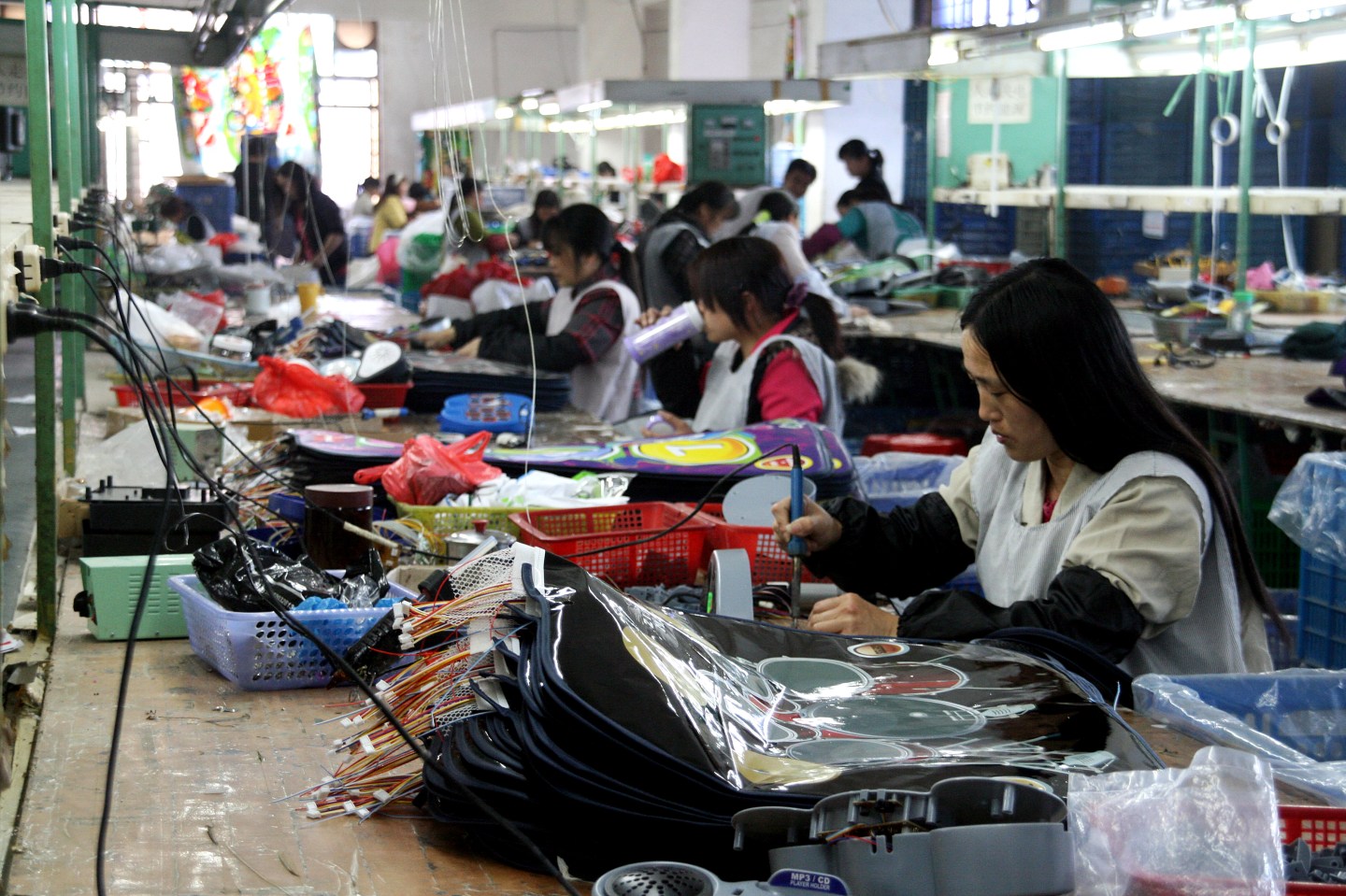 Workers make various toys and games at a