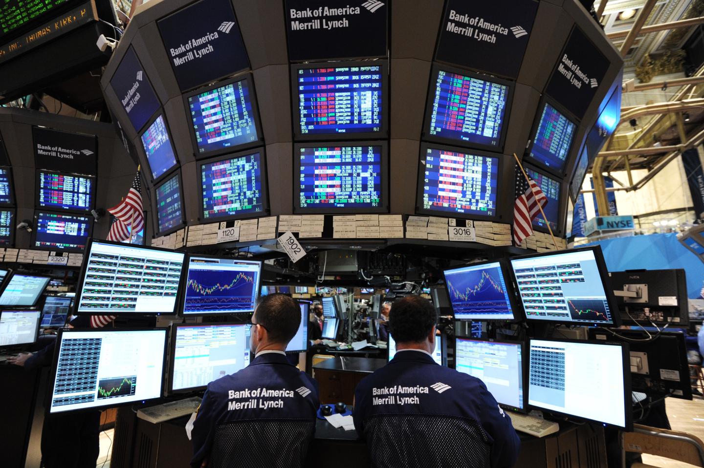 Stock specialists work at the Bank of America/Merrill Lynch post on the floor of the New York Stock Exchange.