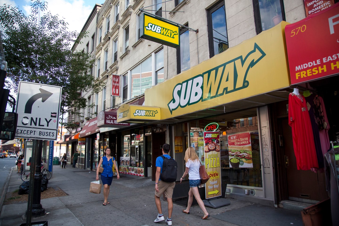 Pedestrians pass a Subway restaurant on Atlantic Avenue in Brooklyn, U.S., on Thursday, August 27, 2015. Photographer: Michael Nagle/Bloomberg