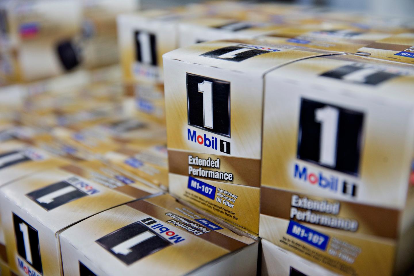 Mobil brand oil filters sit on a shelf in an automotive repair shop in Rockford, Illinois, U.S., on Wednesday, Oct. 28, 2015. Exxon Mobil Corp. is scheduled to report quarterly earnings on Friday, Oct. 30, 3015. Photographer:  Daniel Acker/Bloomberg