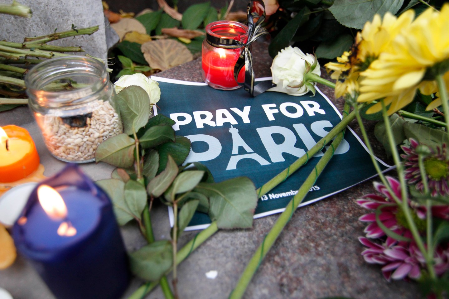 People lay flowers at the French Embassy in Kiev in memory