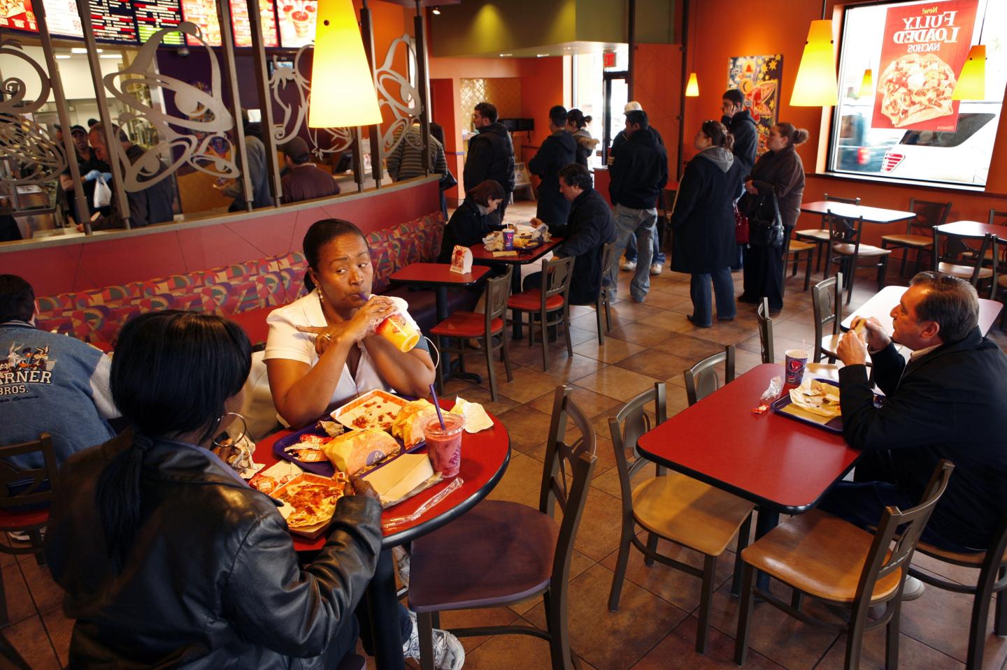 Customers have lunch at a newly remodeled Taco Bell in Flushing, New York, including Claydine Andre