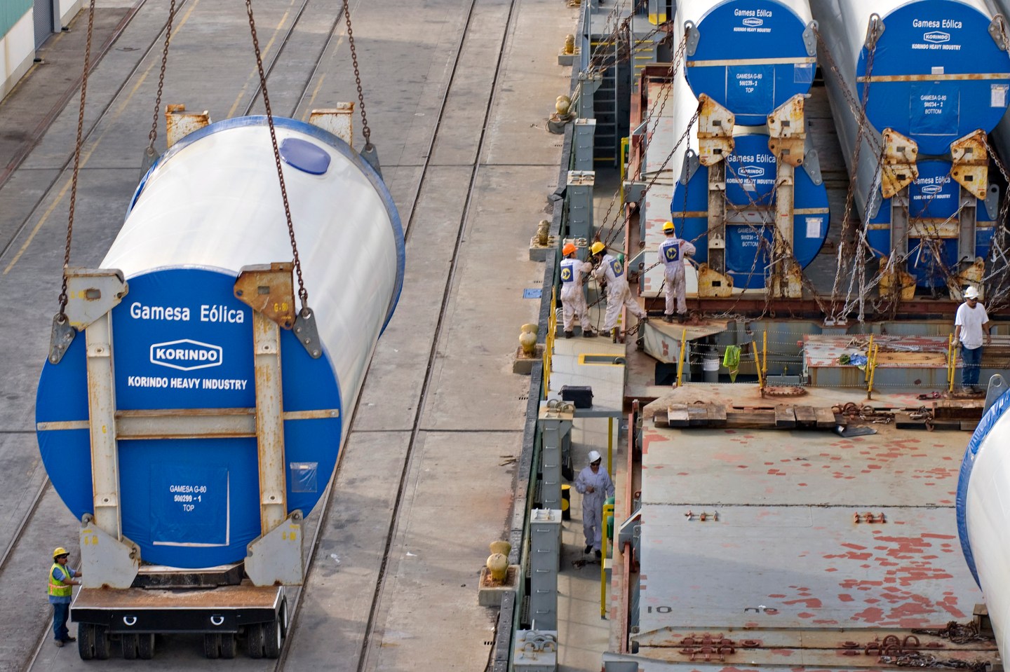 A Gamesa wind turbine tower section is unloaded from the shi