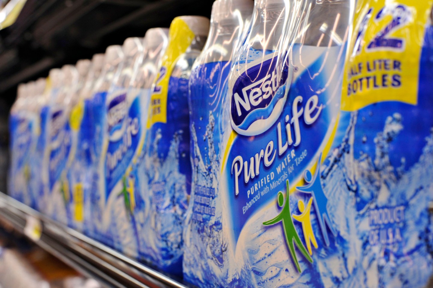 Bottles of Nestle Pure Life water sit on a market shelf in N