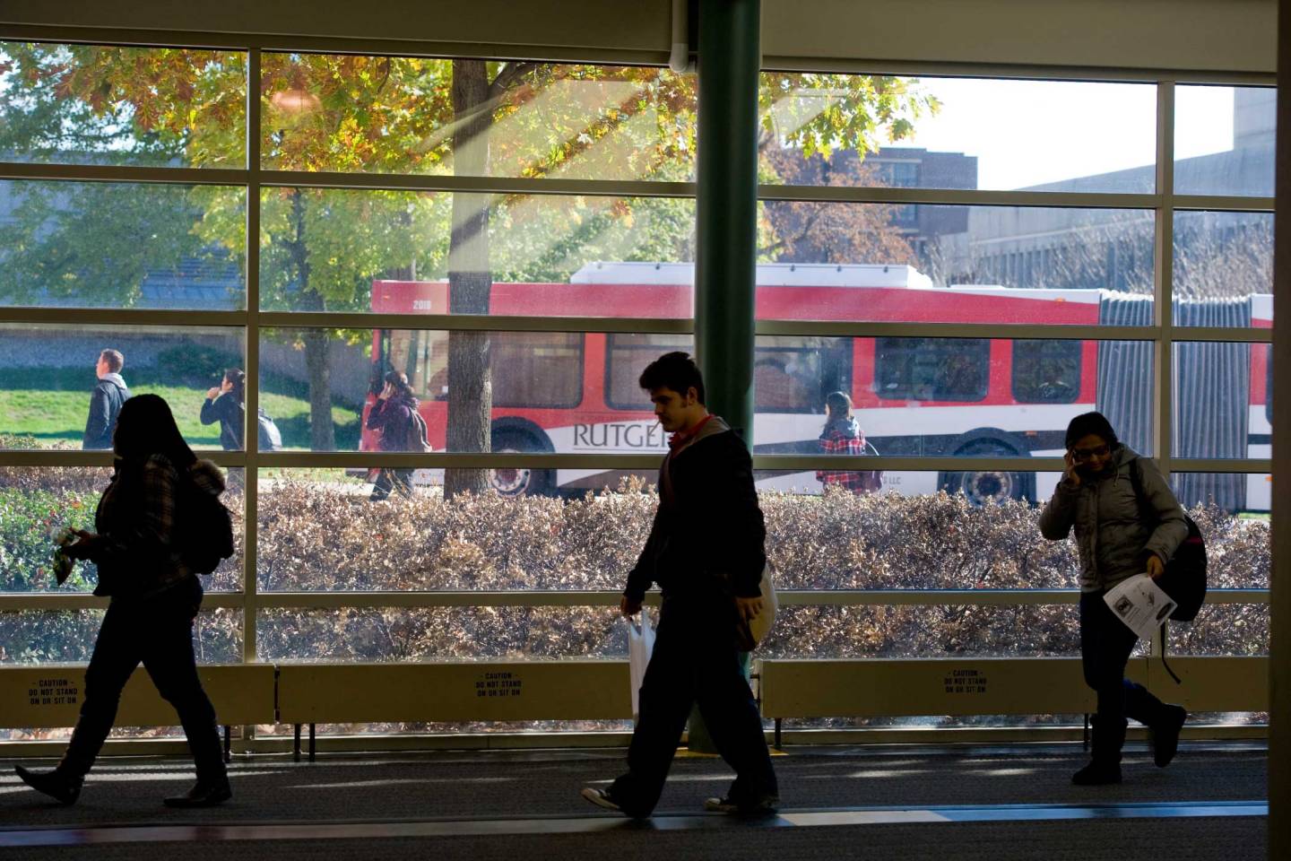 Rutgers buses through the windows of the ARC building on Busch Campus