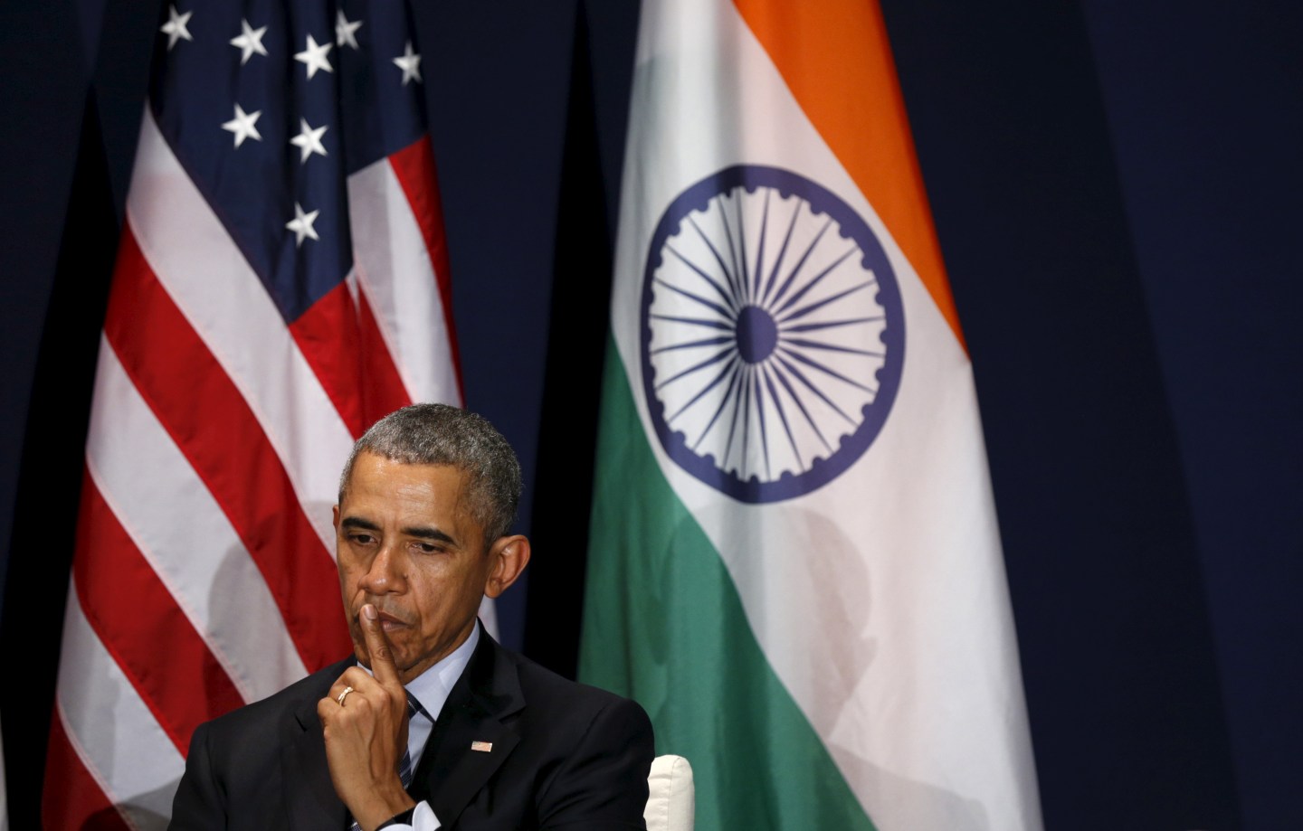 U.S. President Obama listens to Indian Prime Minister Modi speak during their meeting at the climate change summit in Paris