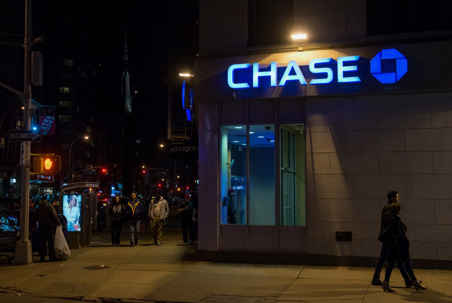 Pedestrians stroll past a Chase bank branch on 12th Street and Broadway in Manhattan, New York, U.S., on Saturday, April 11, 2015. Photographer: Craig Warga/Bloomberg *** Local Caption ***