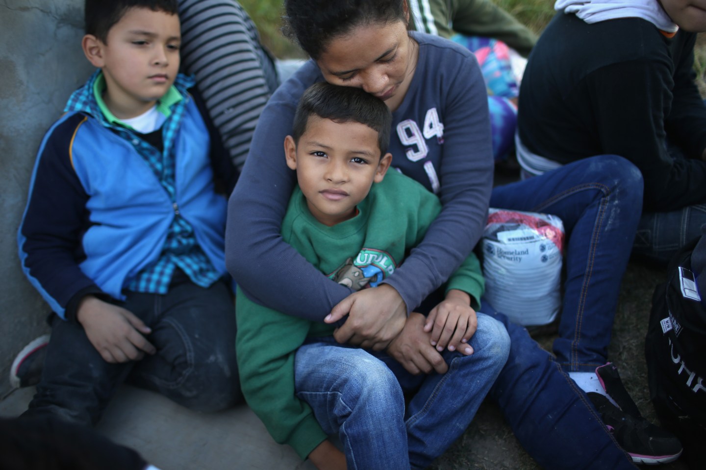 A Honduran mother holds her son, 7, after she turned her family in to U.S. Border Patrol agents near Rio Grande City, Texas.