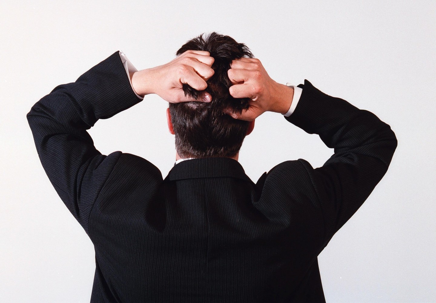 A business man tearing his hair out in frustration, 24 November 2000. AFR GENER