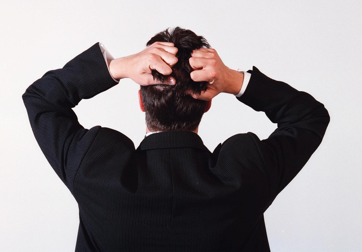 A business man tearing his hair out in frustration, 24 November 2000. AFR GENER
