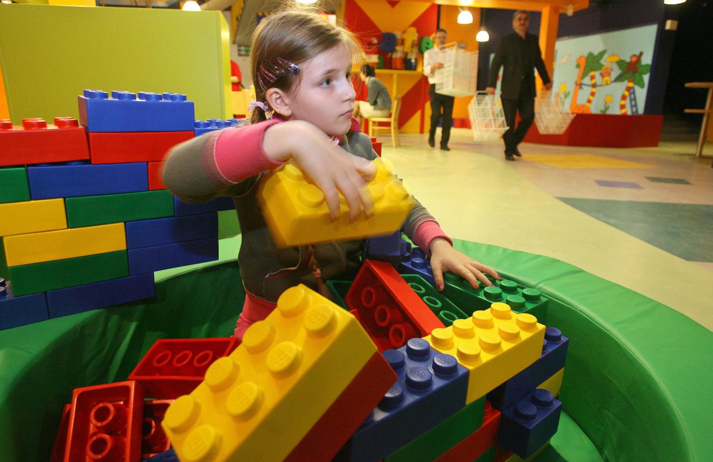 A young girl builds a structure with gia