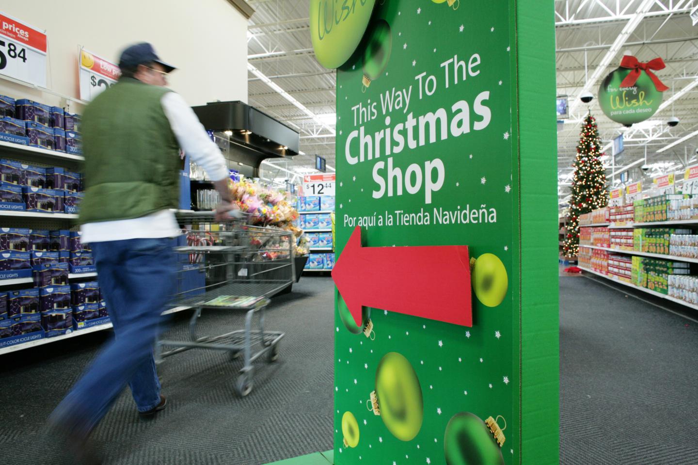 Customers pass the sign indicating the opening of their Chri