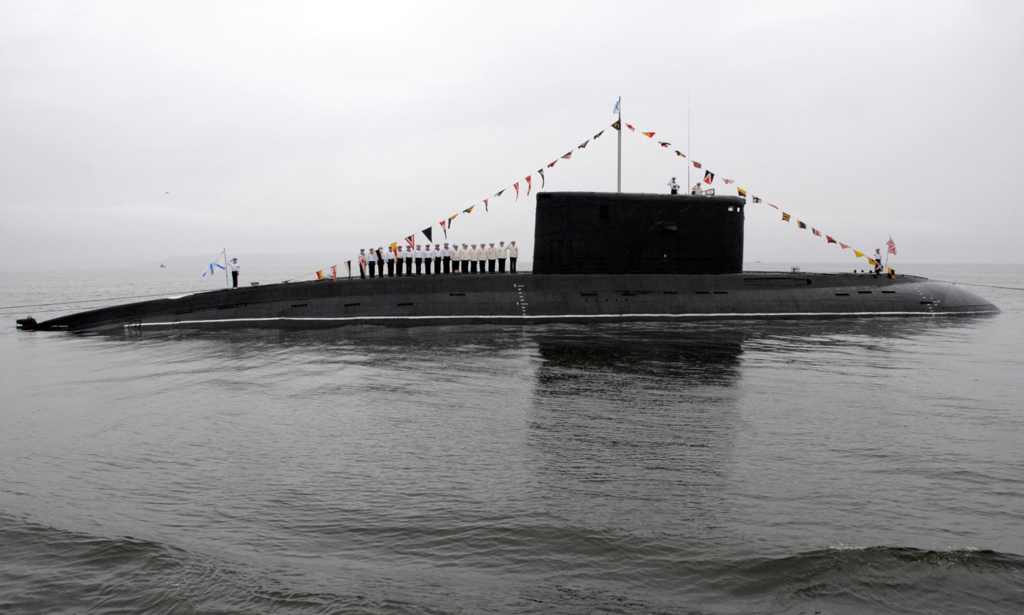 The crew of a Russian Kilo-class diesel submarine line up on its deck during a naval parade rehearsal at Vladivostok's harbour