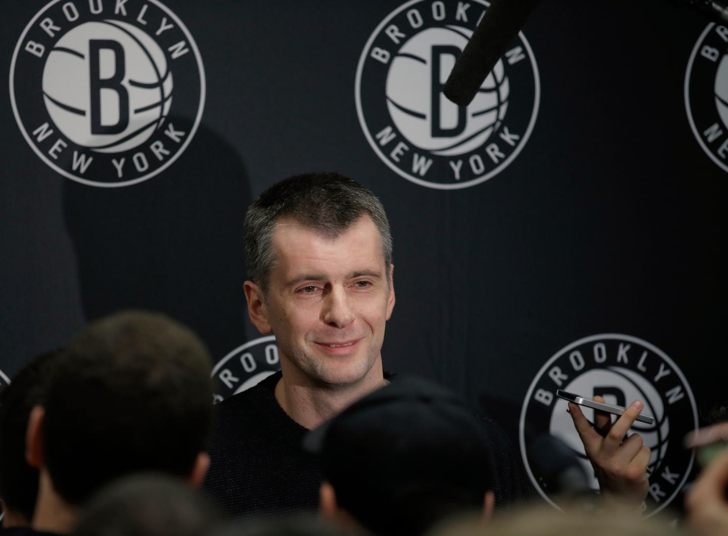 Brooklyn Nets owner Prokhorov talks with the media about his decision to fire head coach Johnson, at half time of their NBA basketball game with the Charlotte Bobcats in New York