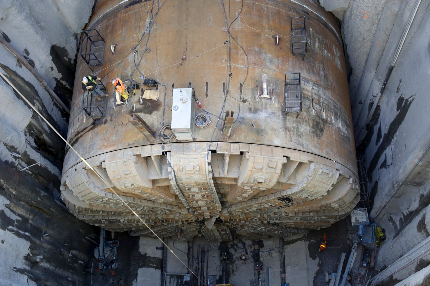 Workers make preparations to lift the cutting head from Bertha, the world's largest tunnel-boring machine, and lift it out for repairs in Seattle, Washington