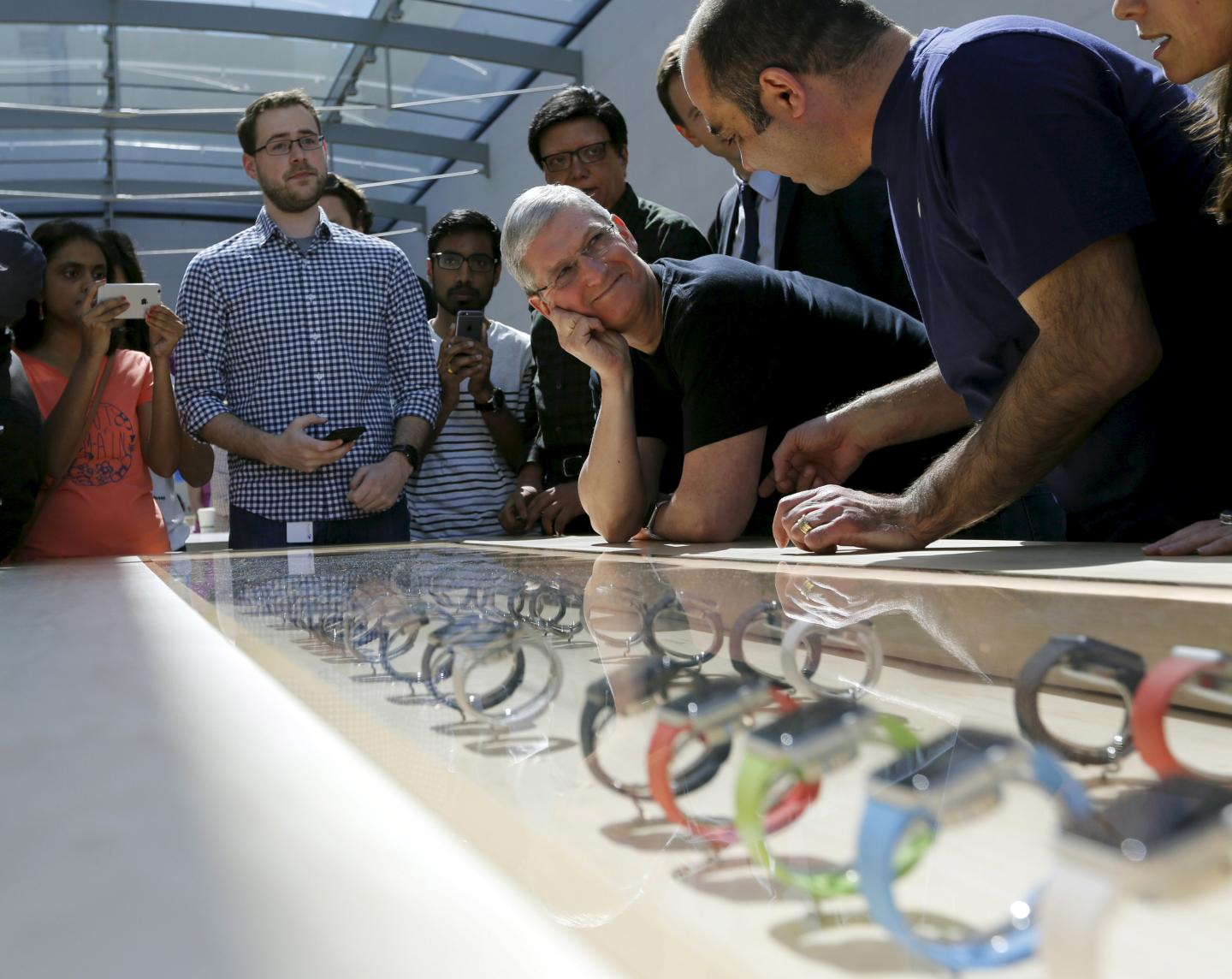 Apple CEO Tim Cook looks over a selection of Apple Watches in Palo Alto