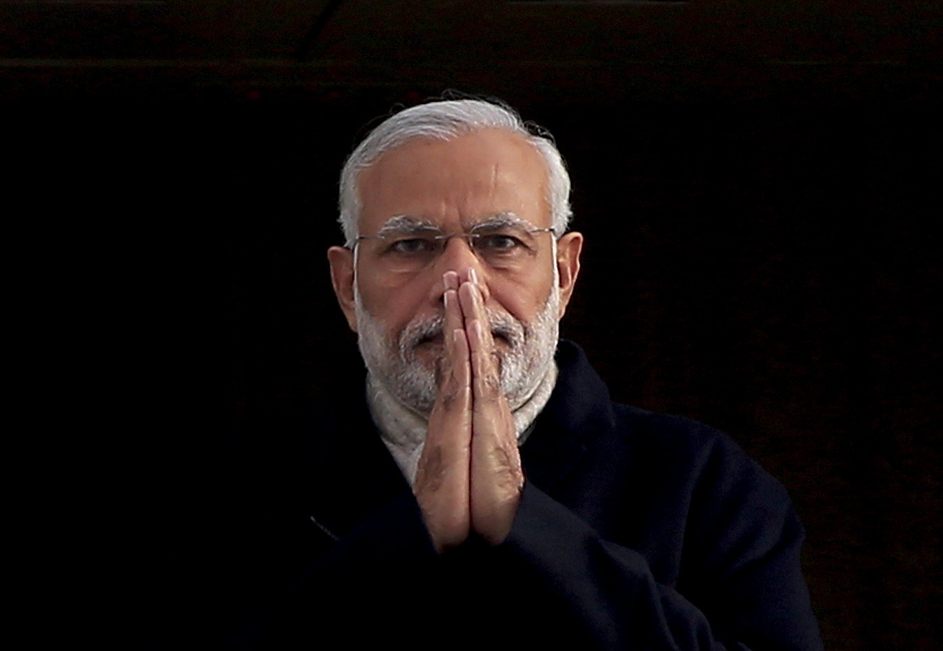 India's Prime Minister Narendra Modi holds up his hands in a "namaste", an Indian gesture of greeting, as he arrives at Heathrow Airport for a three-day official visit, in London