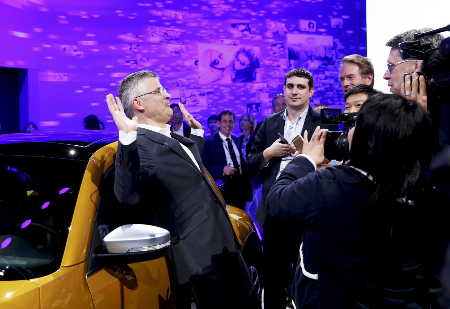 Michael Horn, President and CEO of Volkswagen America, reacts to being mobbed by the media after he apologized for the Volkswagen diesel scandal at the LA Auto Show in Los Angeles