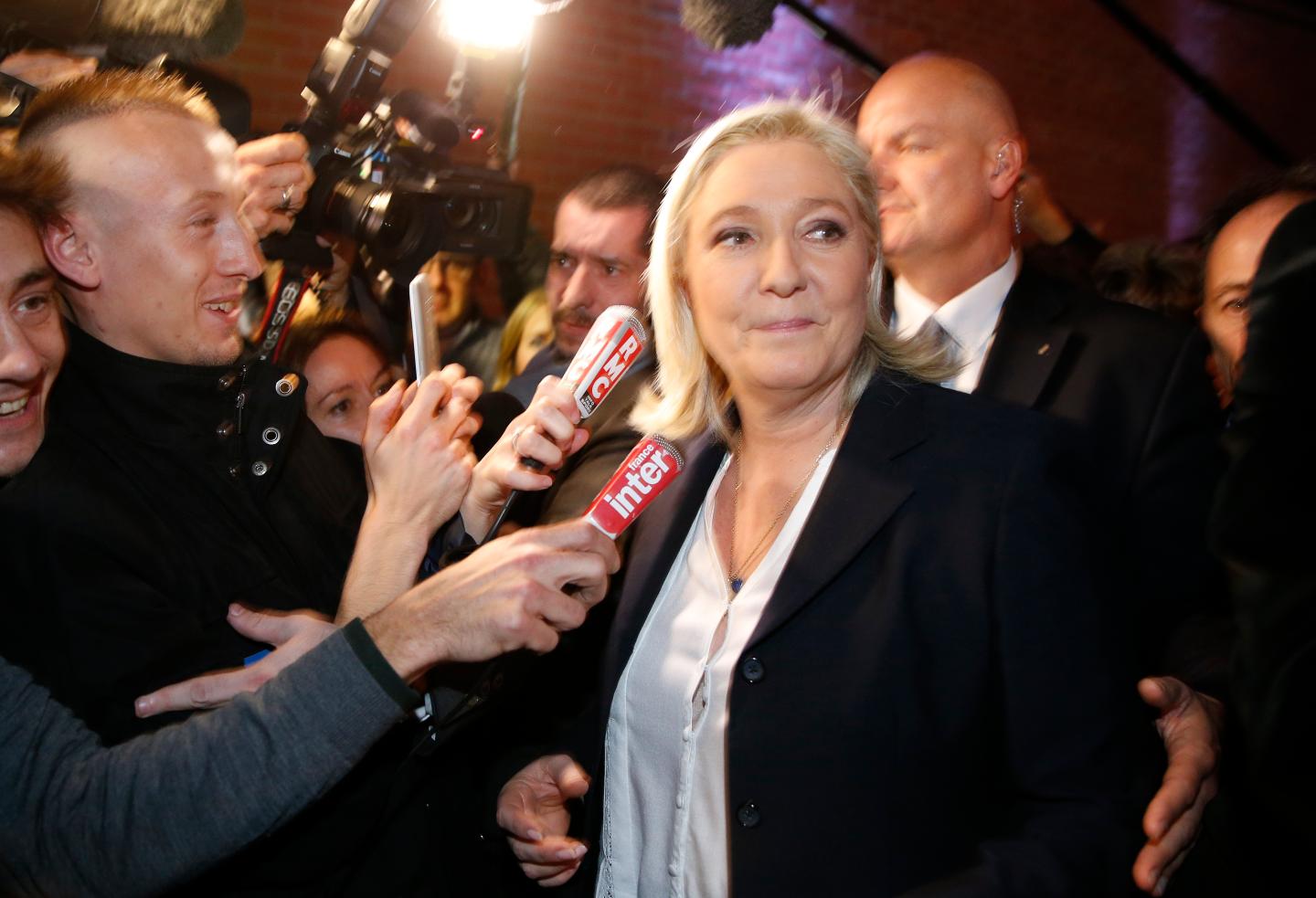 French National Front political party leader and candidate Marine Le Pen leaves after her speech during the first round of the regional elections in Henin-Beaumont