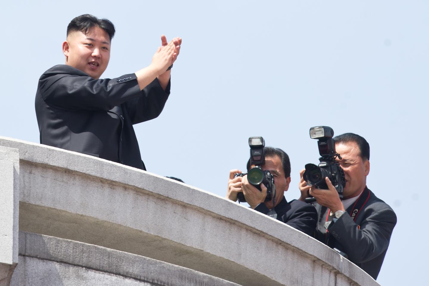 North Korean leader Kim Jong-Un (L) appl