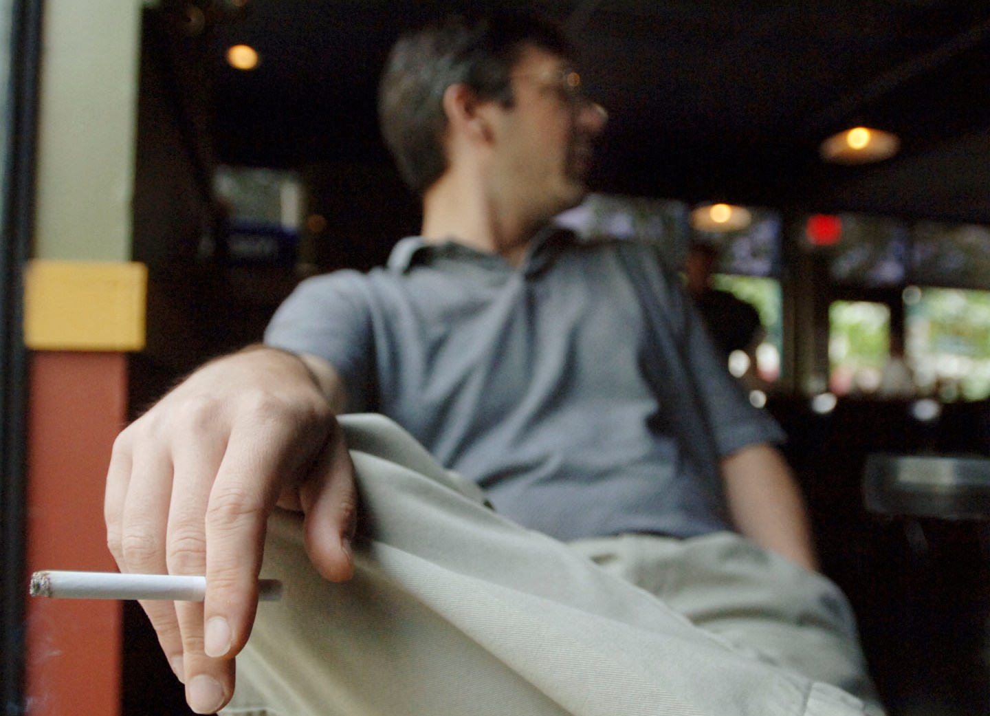 Tim Tash smokes inside a downtown restaurant in Louisville, Kentucky.