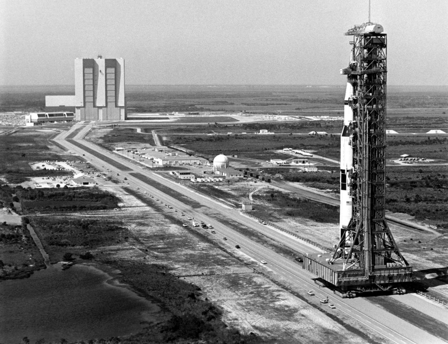 The 363-foot-high Saturn V rocket for the Apollo 10 mission towers over the crawlerway during its rollout from the Vehicle Assembly Building to Launch Pad 39B, four miles away. Apollo 10 marked the first use of Pad B. Astronauts Thomas P. Stafford and Eugene A. Cernan descended in a lunar module spacecraft to 50,000 feet above the moon's surface while John W. Young orbited above in the command module. Image credit: NASA March 11, 1969