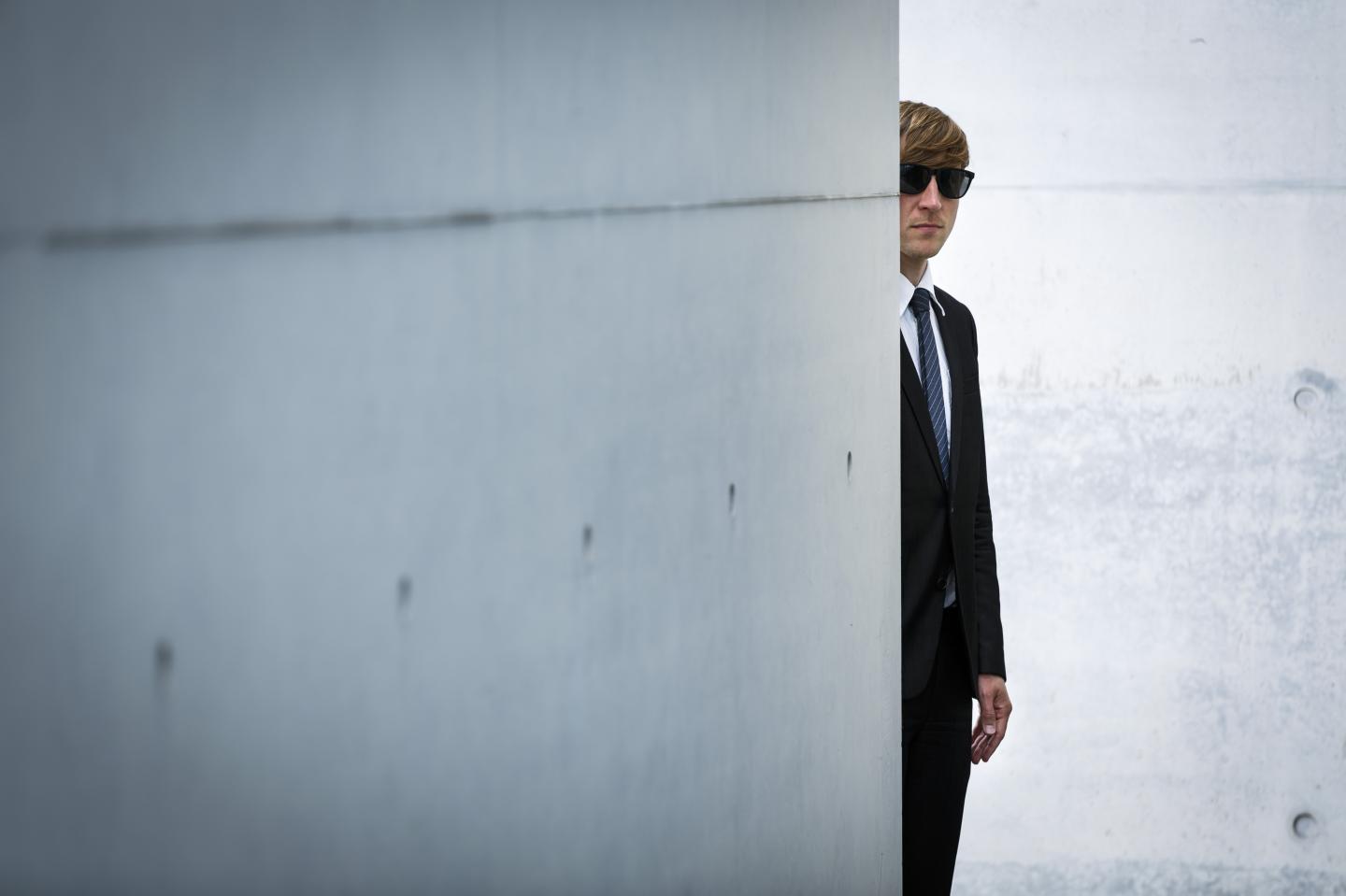 Man in suit reflects