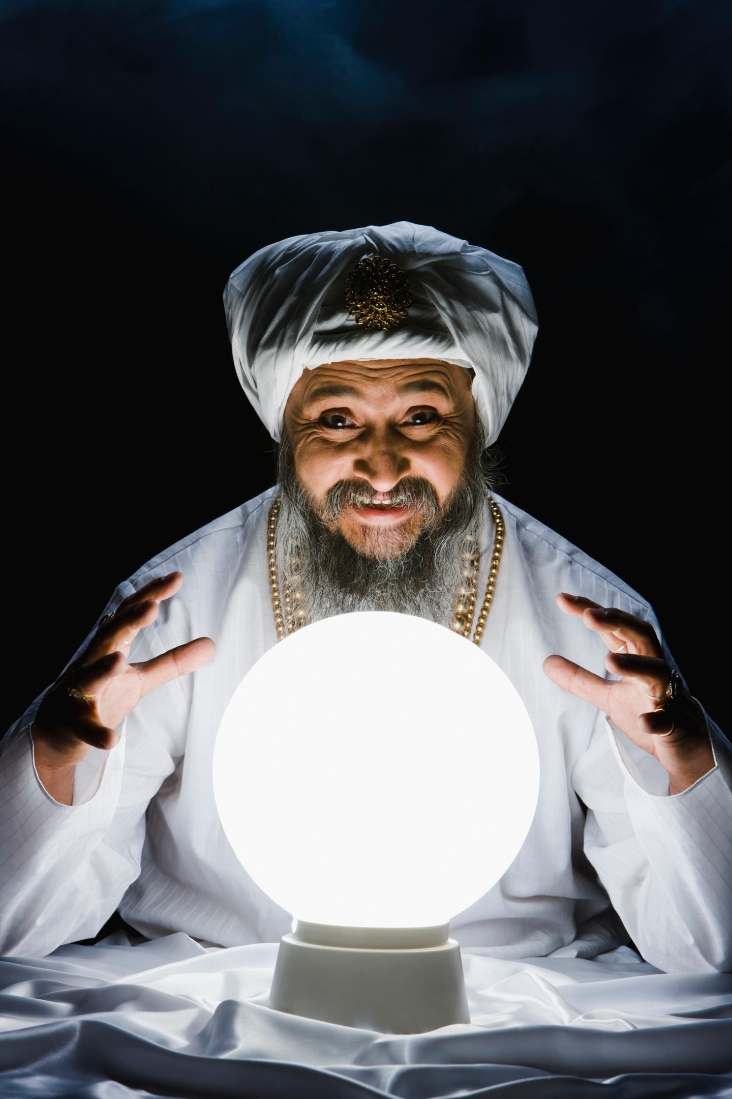 Male fortune teller and crystal ball