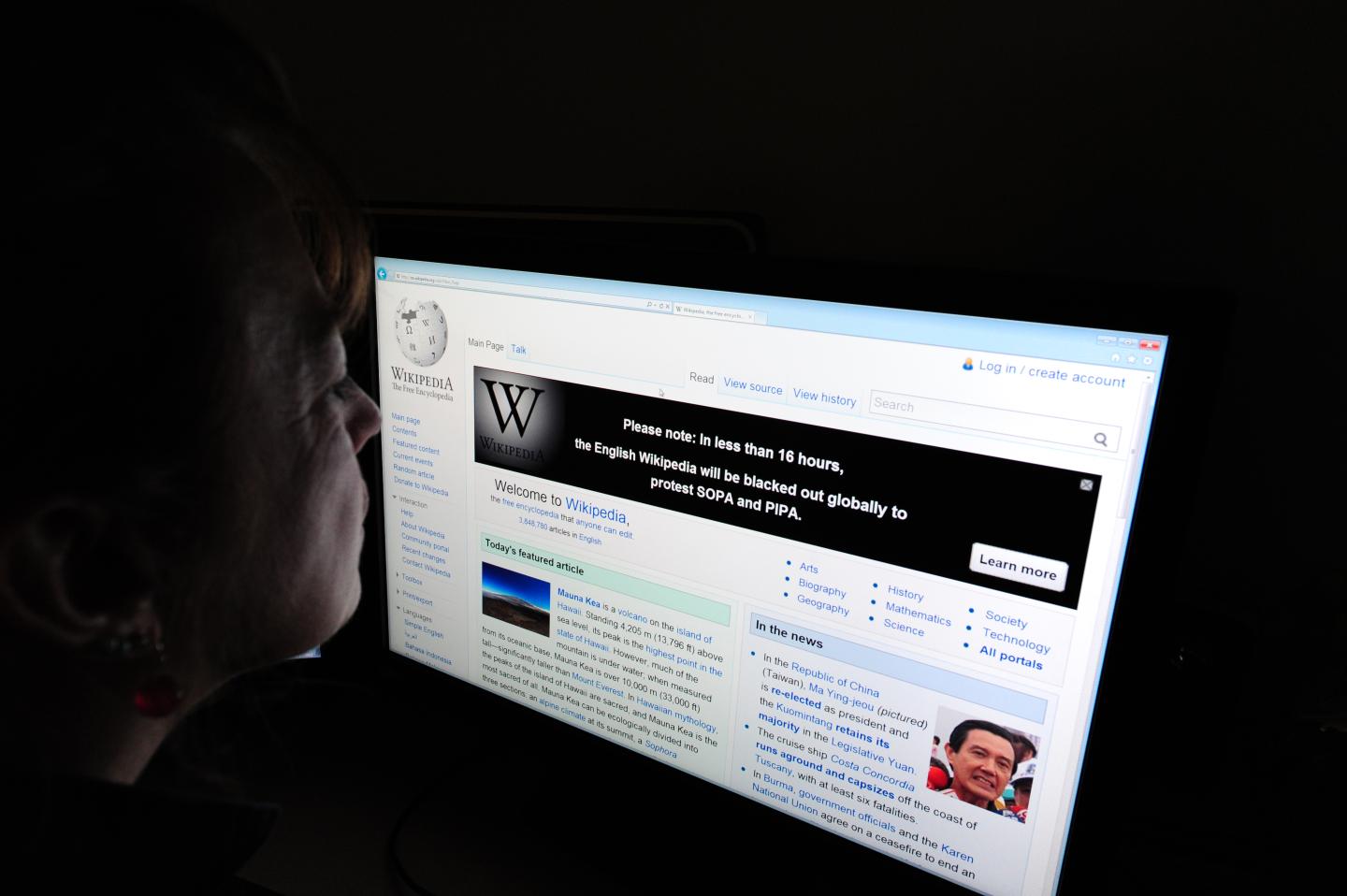 A journalist reads information on the on