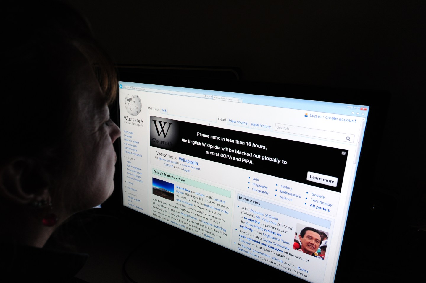 A journalist reads information on the on