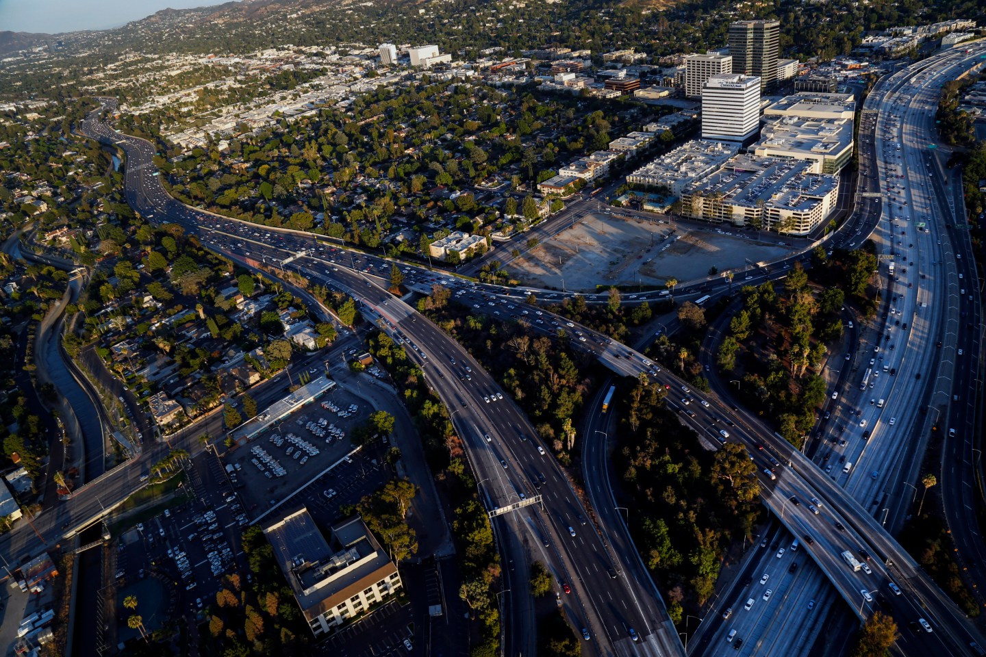 Cars drive in rush hour traffic on the 405 Freeway and US 101 Freeway interchange in this aerial photograph taken over Los Angeles, California, U.S., on Friday, July 10, 2015. Photographer: Patrick T. Fallon/Bloomberg