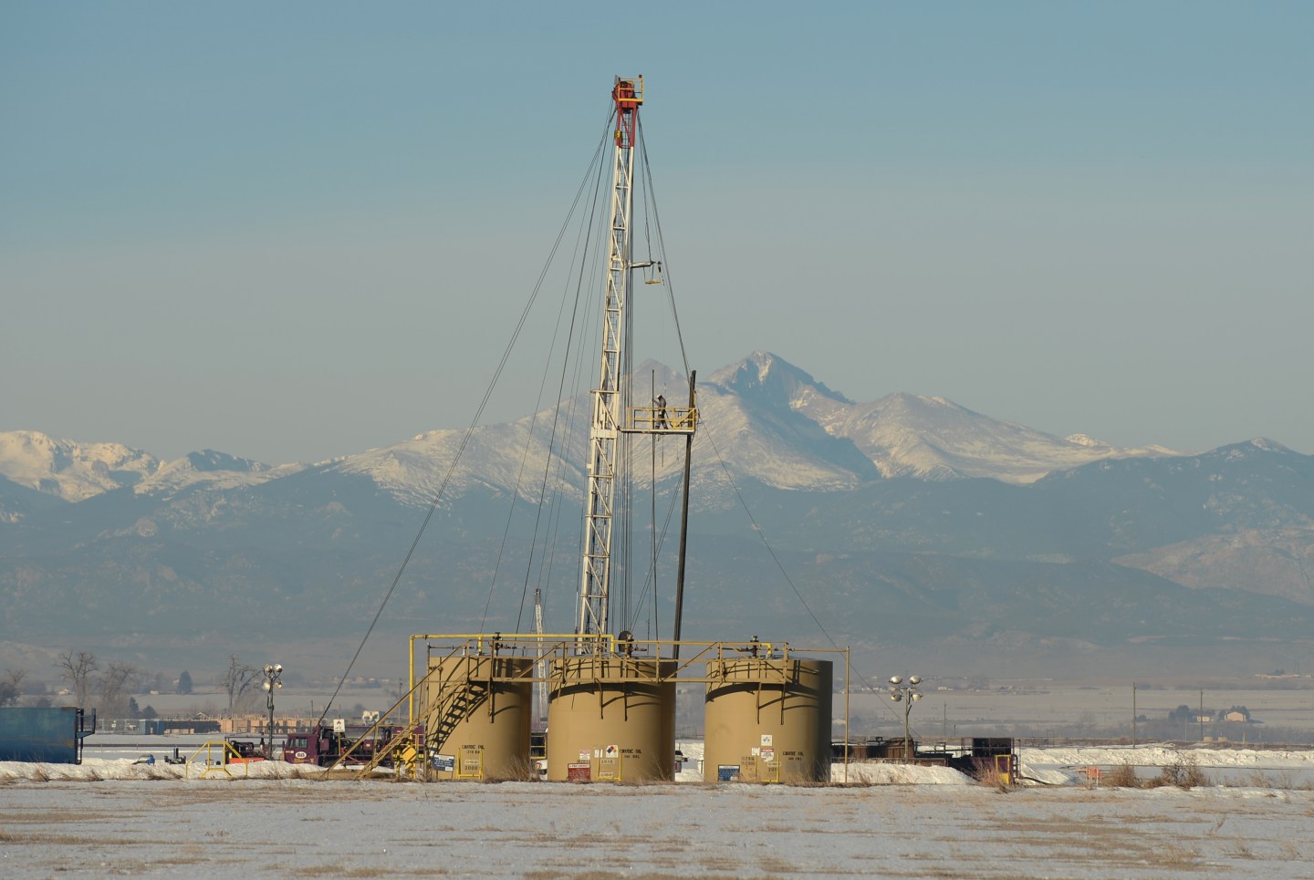 GREELEY, CO - JANUARY 27: An oil field worker places well pipe on a rig in Weld County, Colorado, January, 27, 2016. With oil prices now tumbling into drilling in Colorado has slowed. (Photo by RJ Sangosti/The Denver Post)