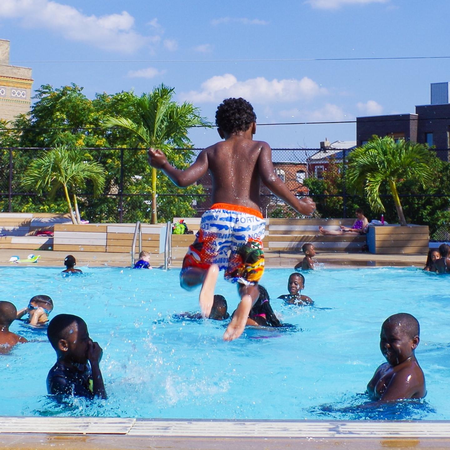 Child jumping into pool
