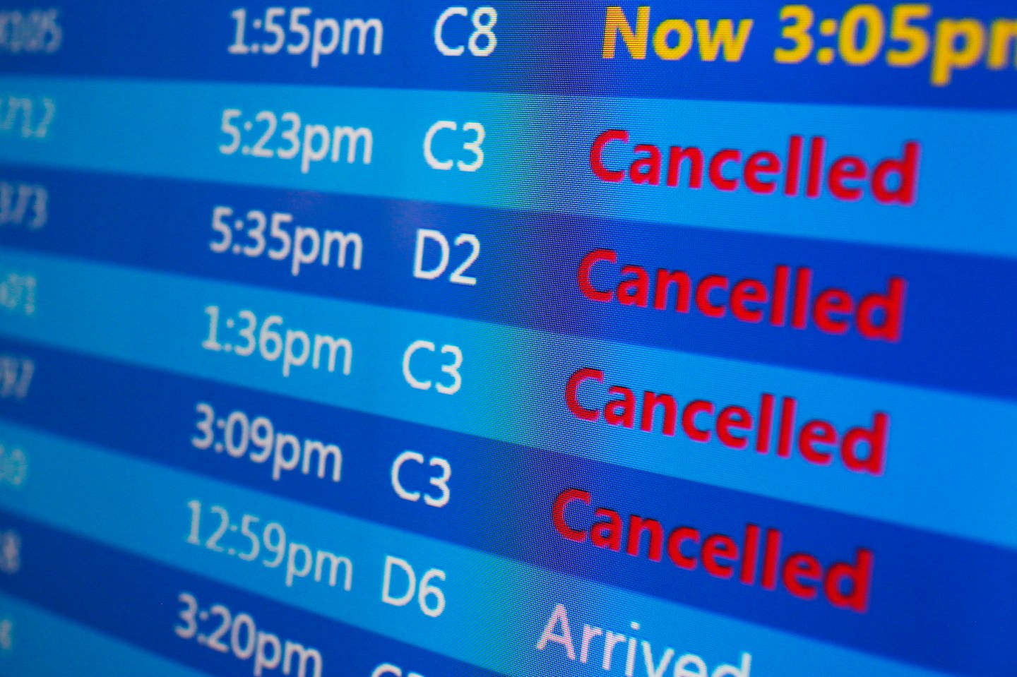 Cancelled flights are displayed on a status board at New York's Laguardia Airport ahead of a powerful approaching winter storm