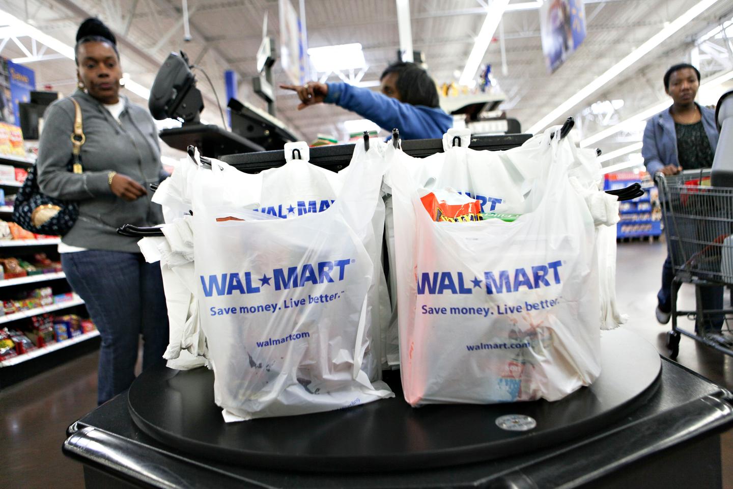 Wal-Mart logos apprear on shopping bags at a cash register i