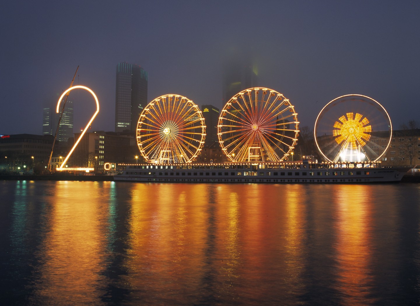 Germany, Frankfort Main: The turn of the millennium. Three ferris wheels symbolizing the year 2000