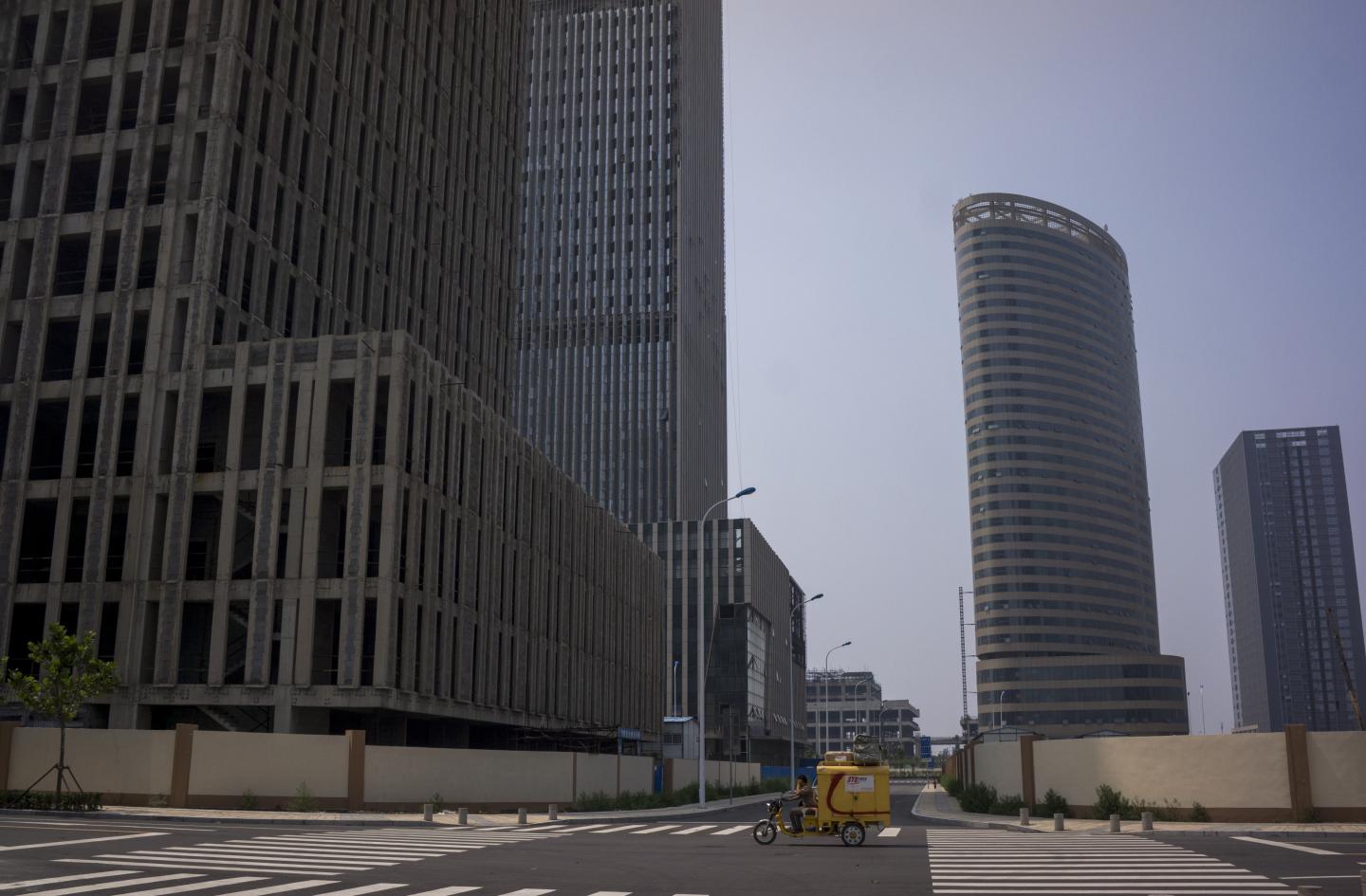 Unfinished buildings and vacant streets in Xiangluo Bay.