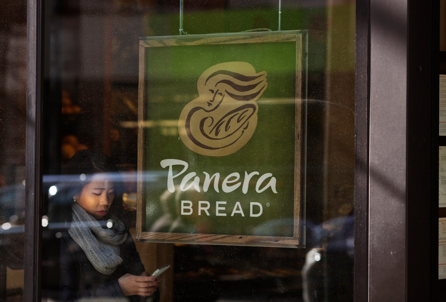 Pedestrians walk by a Panera Bread restaurant in Midtown Manhattan, New York, NY, Tuesday, February 10, 2015.