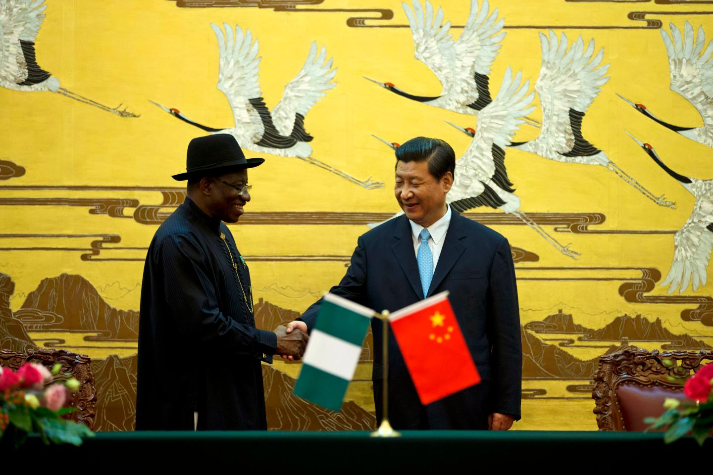 Chinese President Xi shakes hands with Nigerian President Jonathan after their ministers signed agreements in Beijing