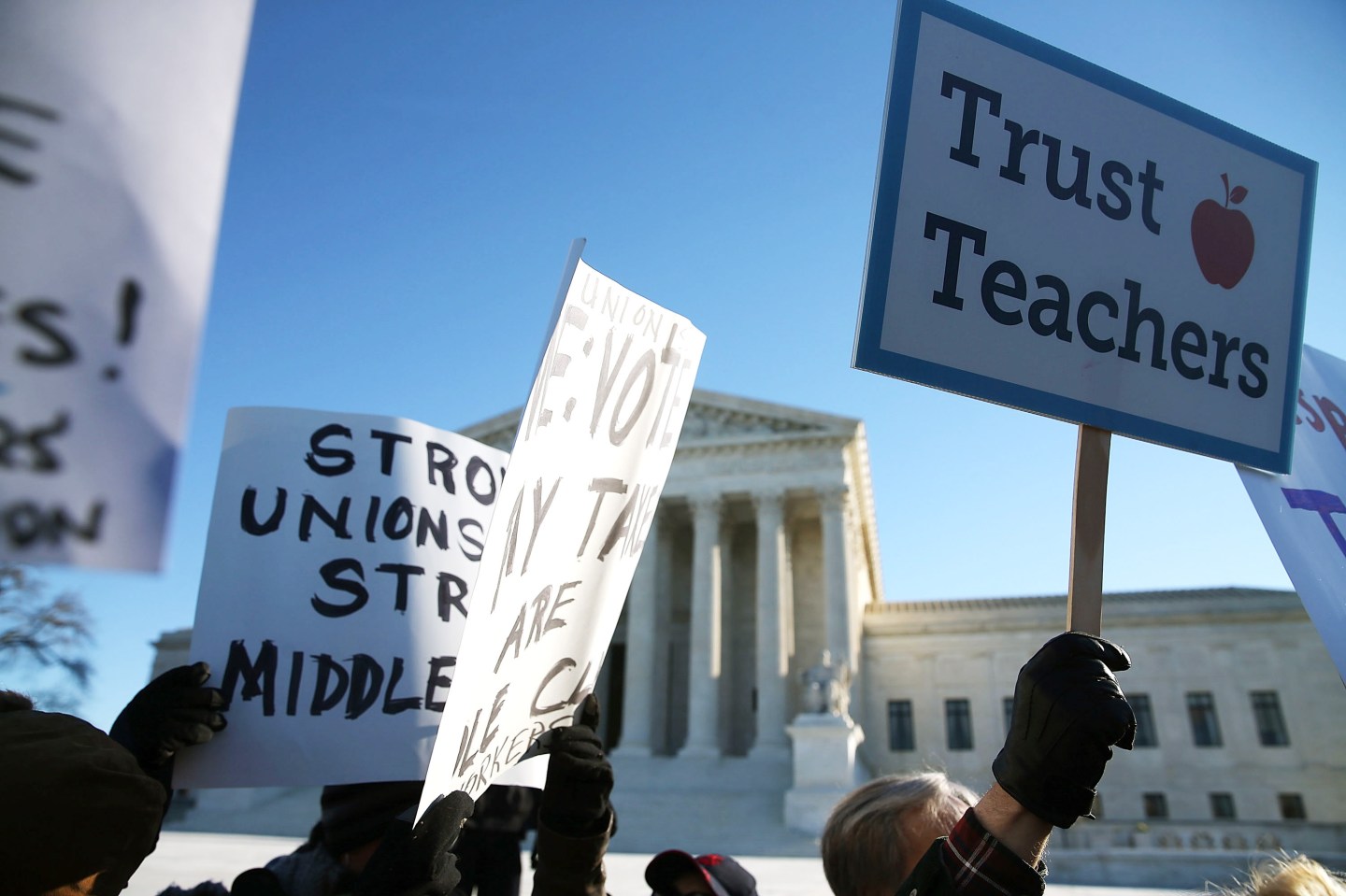 WASHINGTON, DC - JANUARY 11: People for and against unions hold up signs in front of the US Supreme Court building January 11, 2016 in Washington, DC. The high court is hearing arguments in the Friedrichs v. California Teachers Association case.ÊThe case will decide whether California and twenty two other states can make public-employees, such as public school teacher Rebecca Friedrichs, to pay union agency fees. (Photo by Mark Wilson/Getty Images)