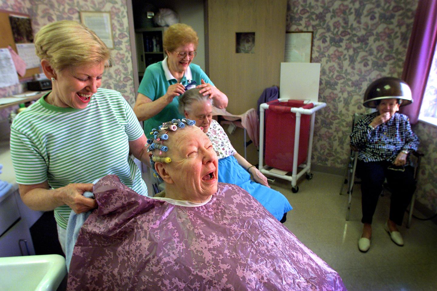 Sister Anne Agatha Muser, center, shares a joke with beauticians Veronica Smith, left, and Agnes Roc