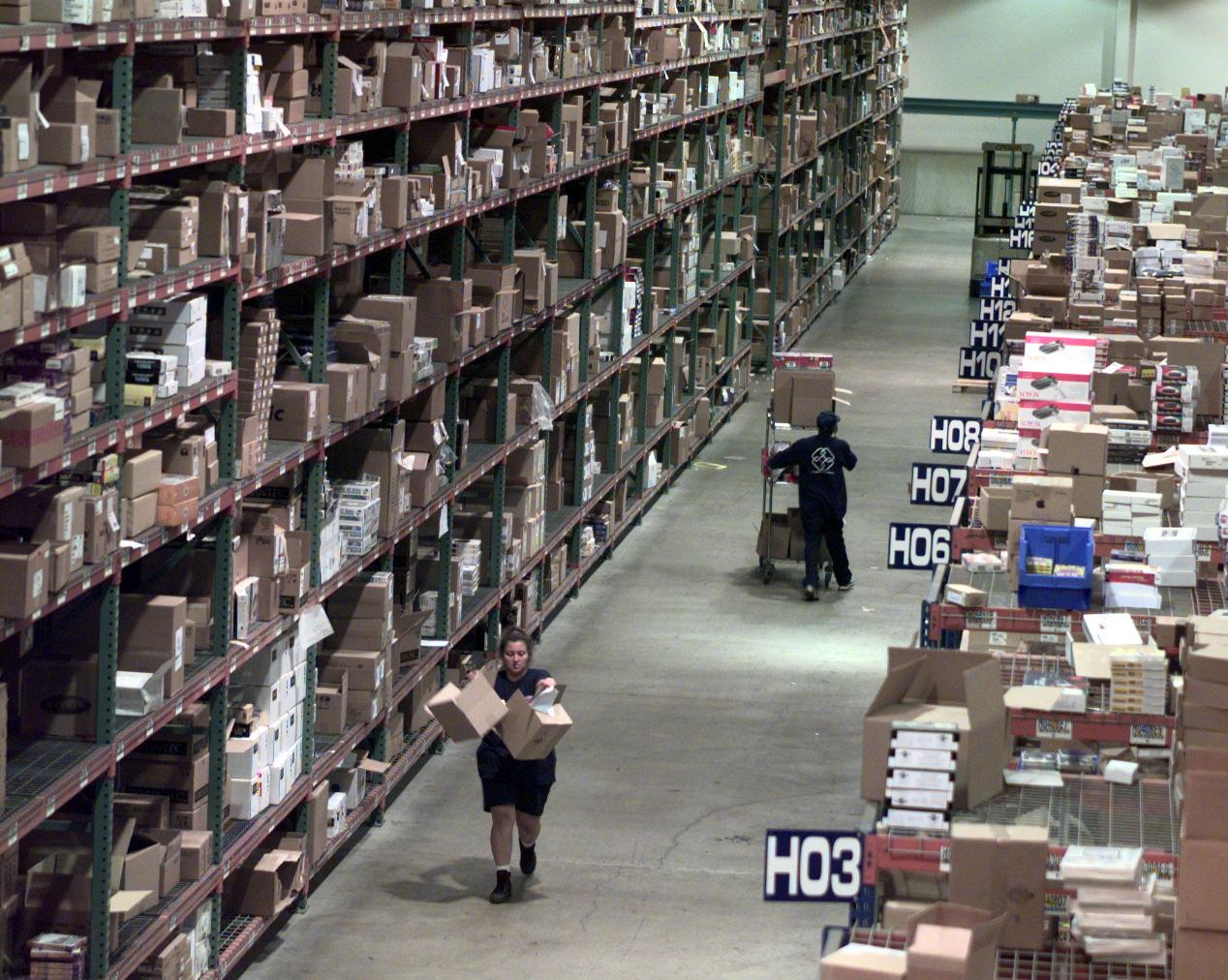 FI.Ingram.shelves.D.072298.KRHWarehouse workers pick up orders for games, software, hard drives an
