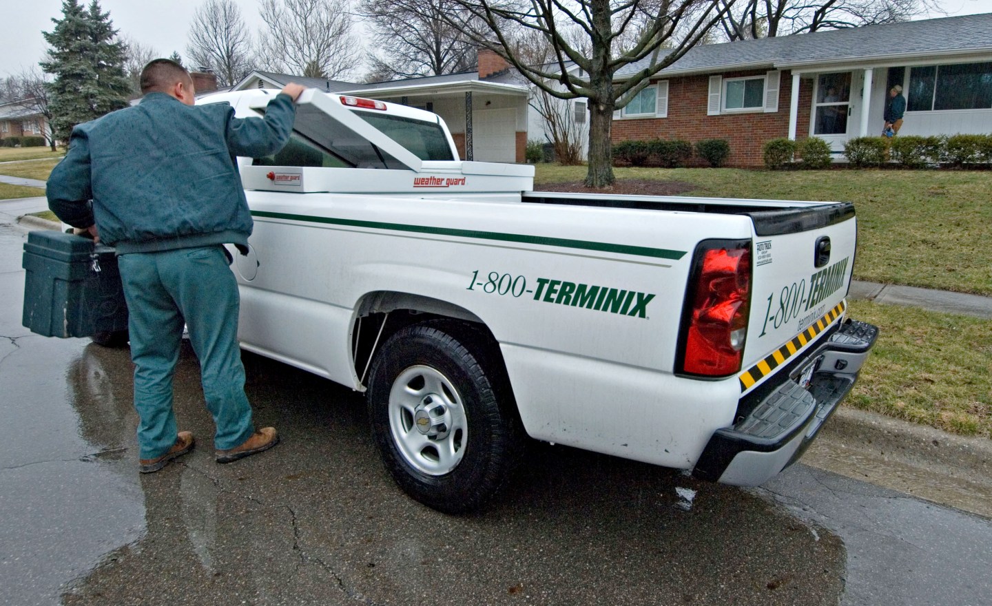 Terminix employee David Romeo pulls a work box from his truc