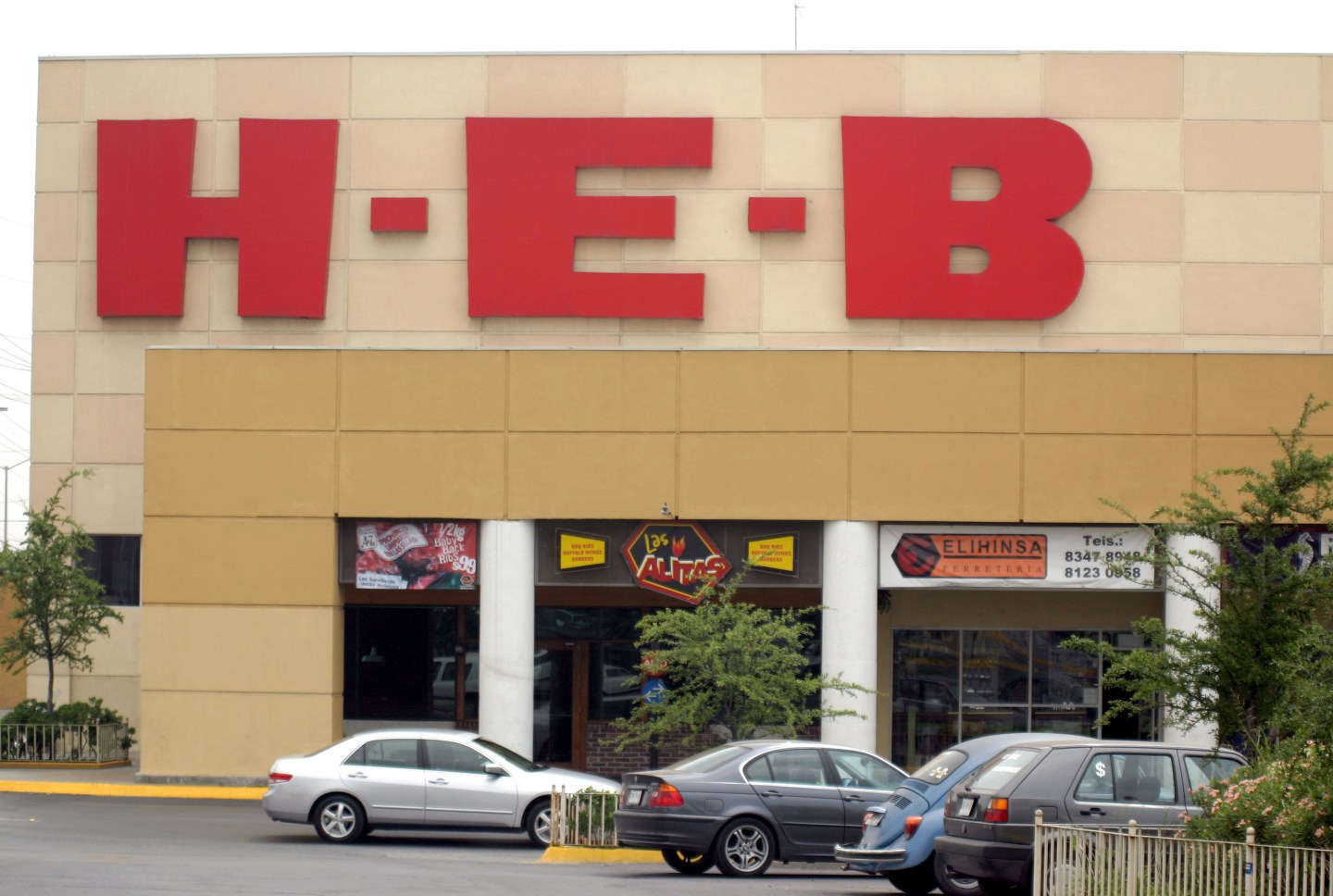 The chain's logo hangs over the entrance to an H-E-B superma
