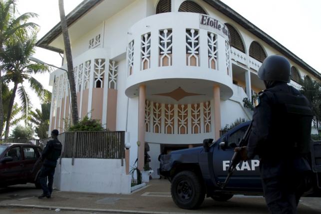 Soldiers stand guard in front of the Etoile du Sud hotel in Bassam