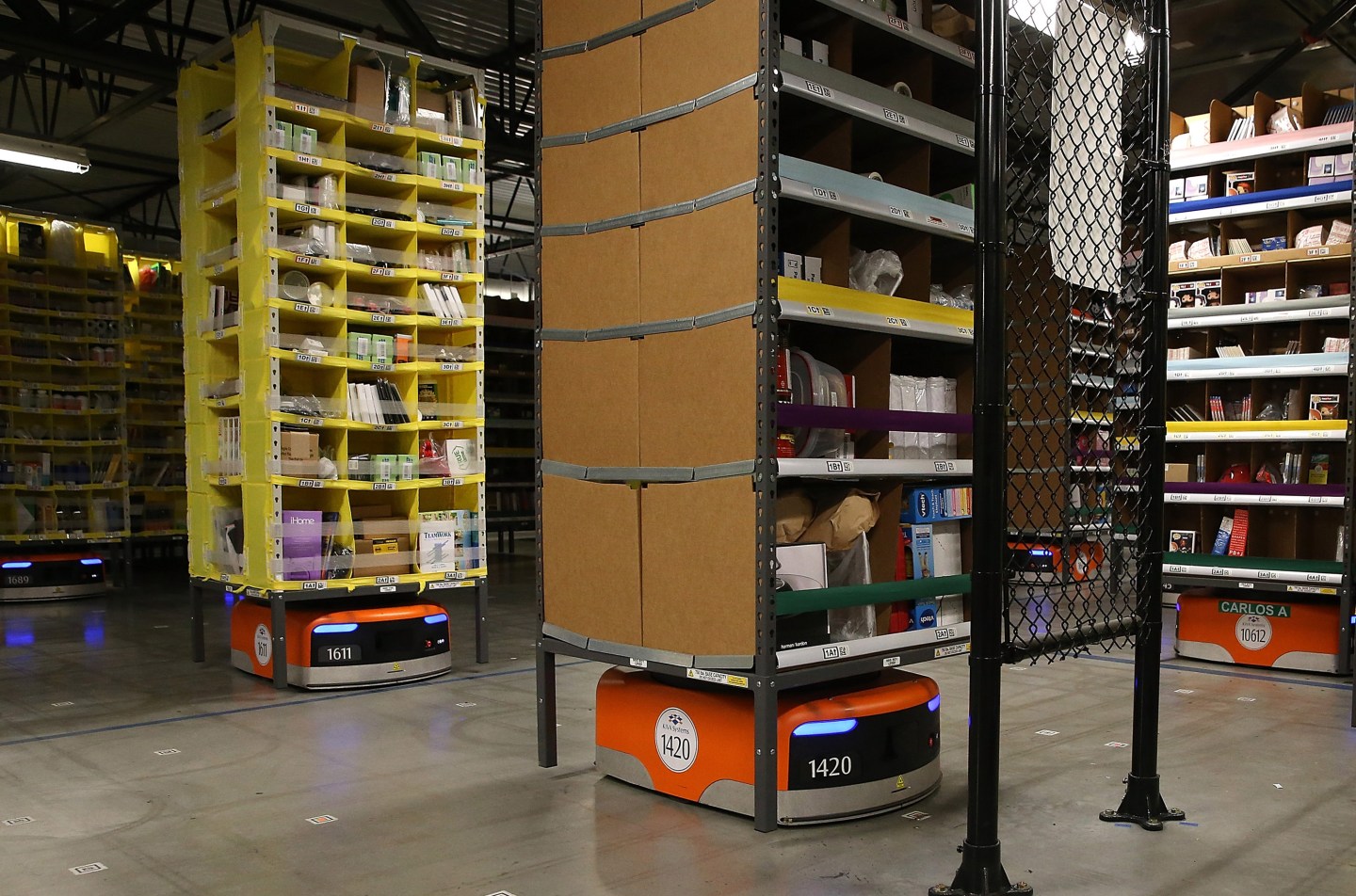 TRACY, CA - JANUARY 20: Kiva robots move racks of merchandise at an Amazon fulfillment center on January 20, 2015 in Tracy, California. Amazon officially opened its new 1.2 million square foot fulfillment center in Tracy, California that employs more than 1,500 full time workers as well as 3,000 Kiva robots that can fetch merchandise for workers and are capable of lifting up to 750 pounds. Amazon is currently using 15,000 of the robots spread over 10 fulfillment centers across the country. (Photo by Justin Sullivan/Getty Images)