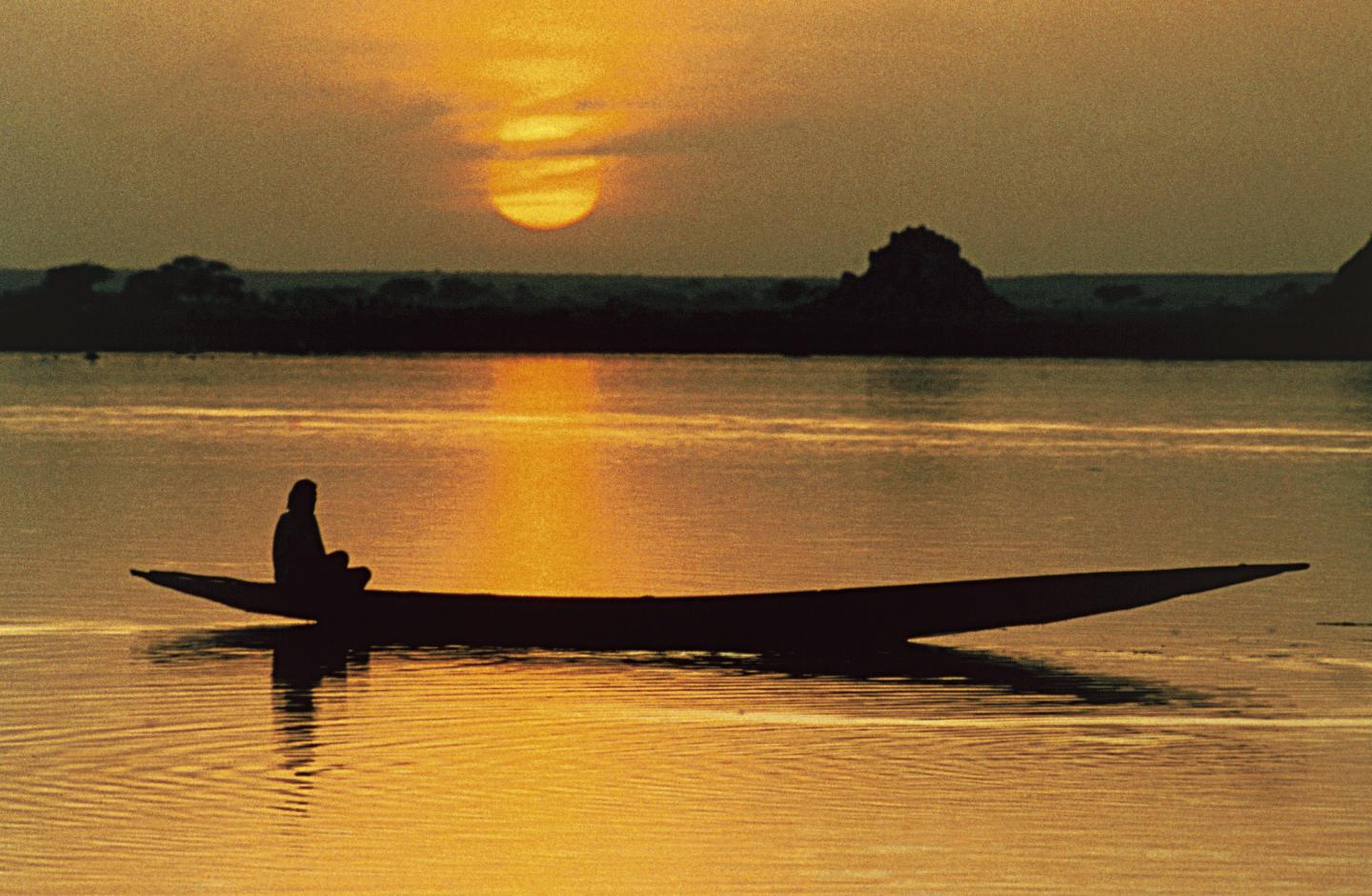 Pirogue on Niger river at sunset