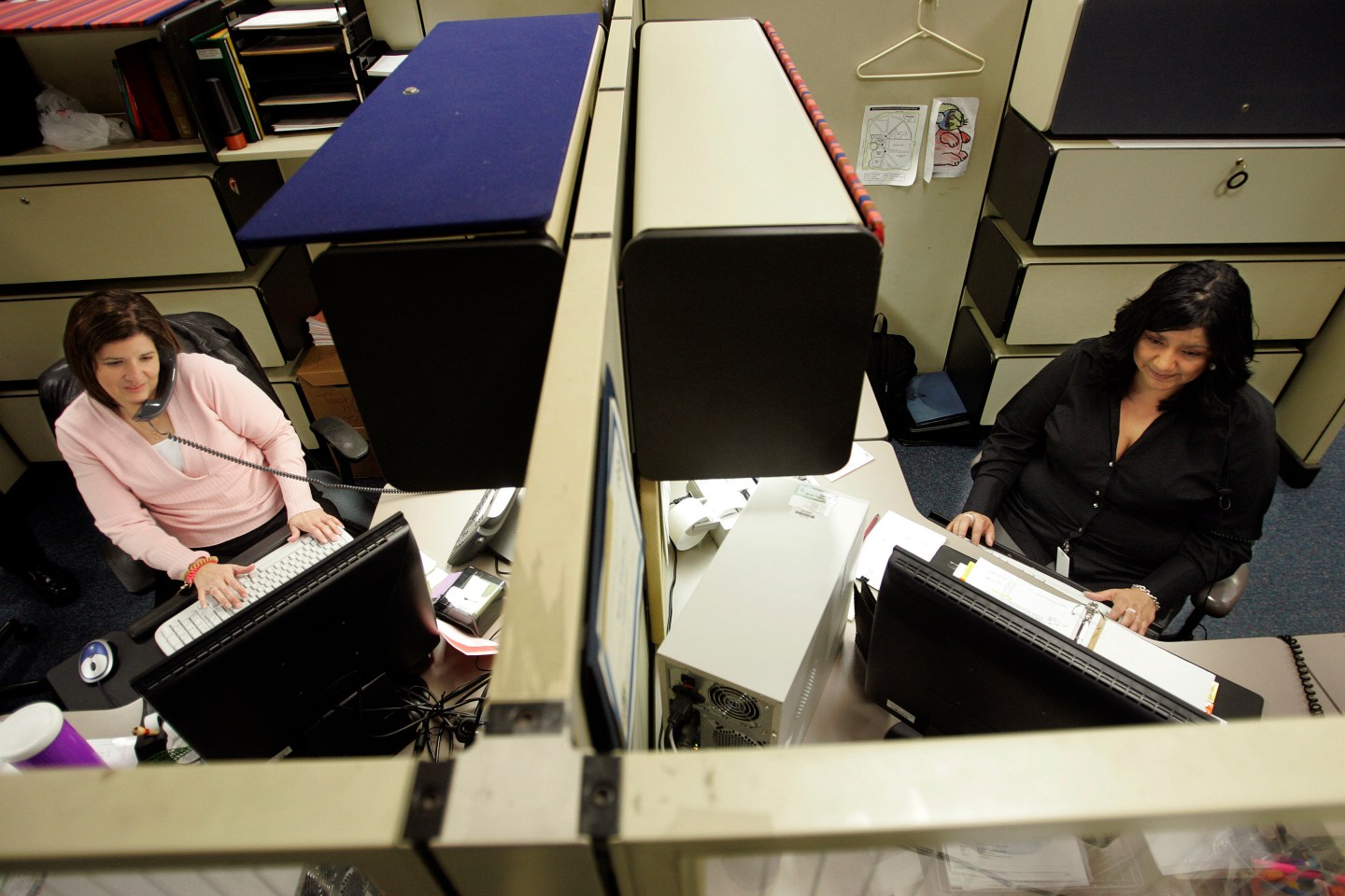Lisa Valverde, 38, right, a fiscal assistant at the Ventura County treasury tax collector's office