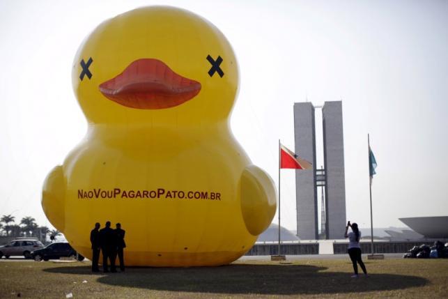 File photo of a giant inflatable doll in the shape of a duck in front of the National Congress during a protest against tax increases in Brasilia