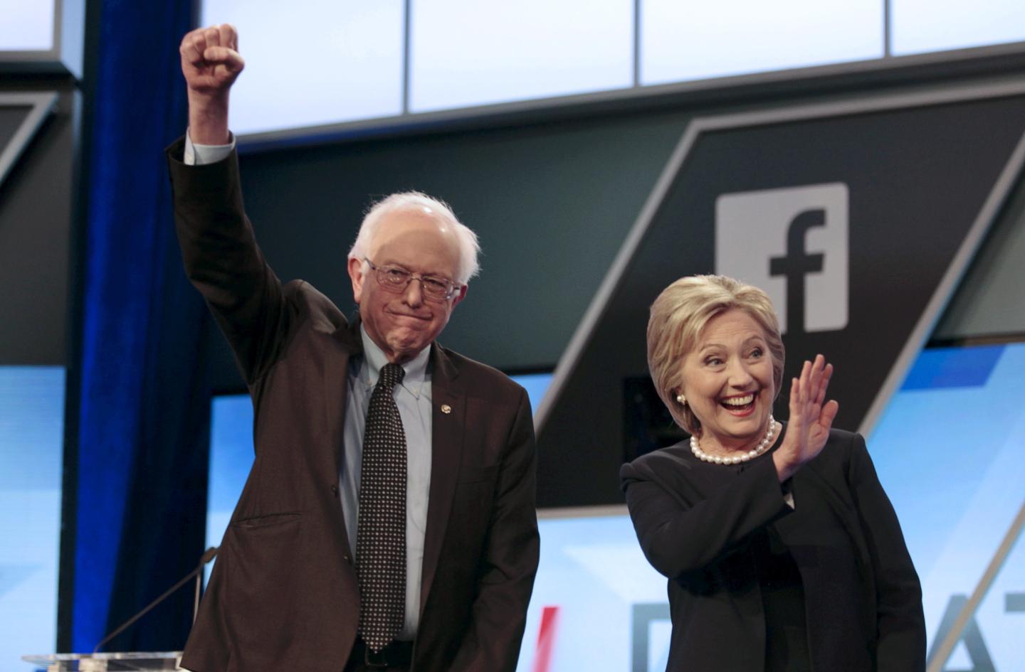 Democratic U.S. presidential candidates Senator Bernie Sanders and Hillary Clinton wave before the start of the Univision News and Washington Post Democratic U.S. presidential candidates debate in Kendall